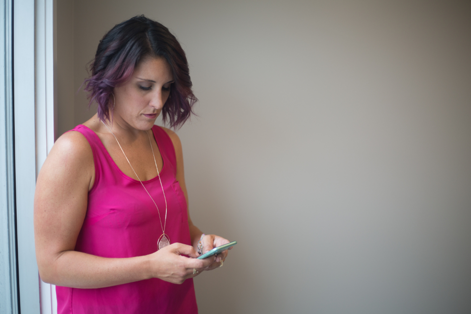 A person using their phone to send a text